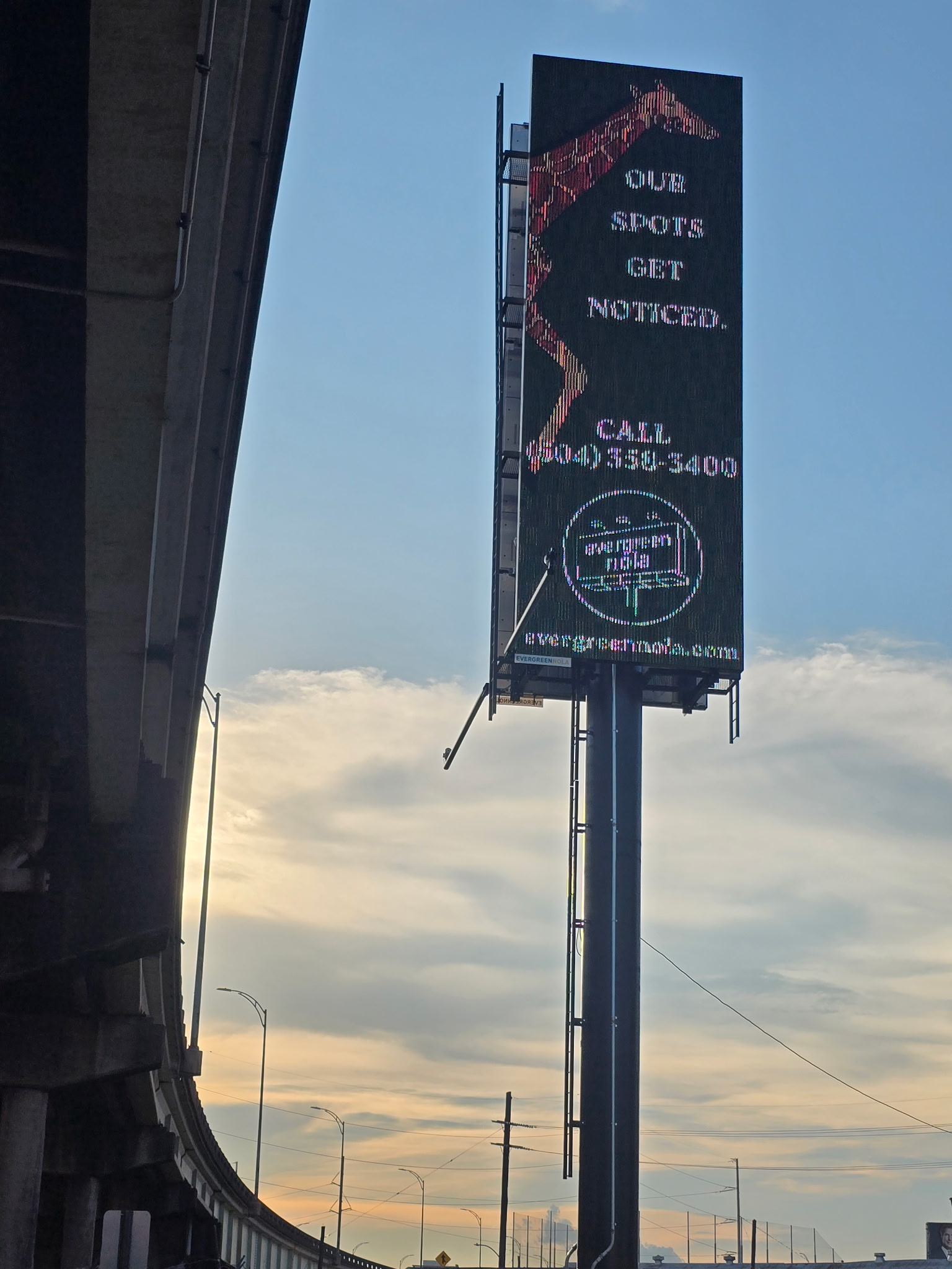 The I-10 digital billboard displaying a giraffe beside the words our spots get noticed