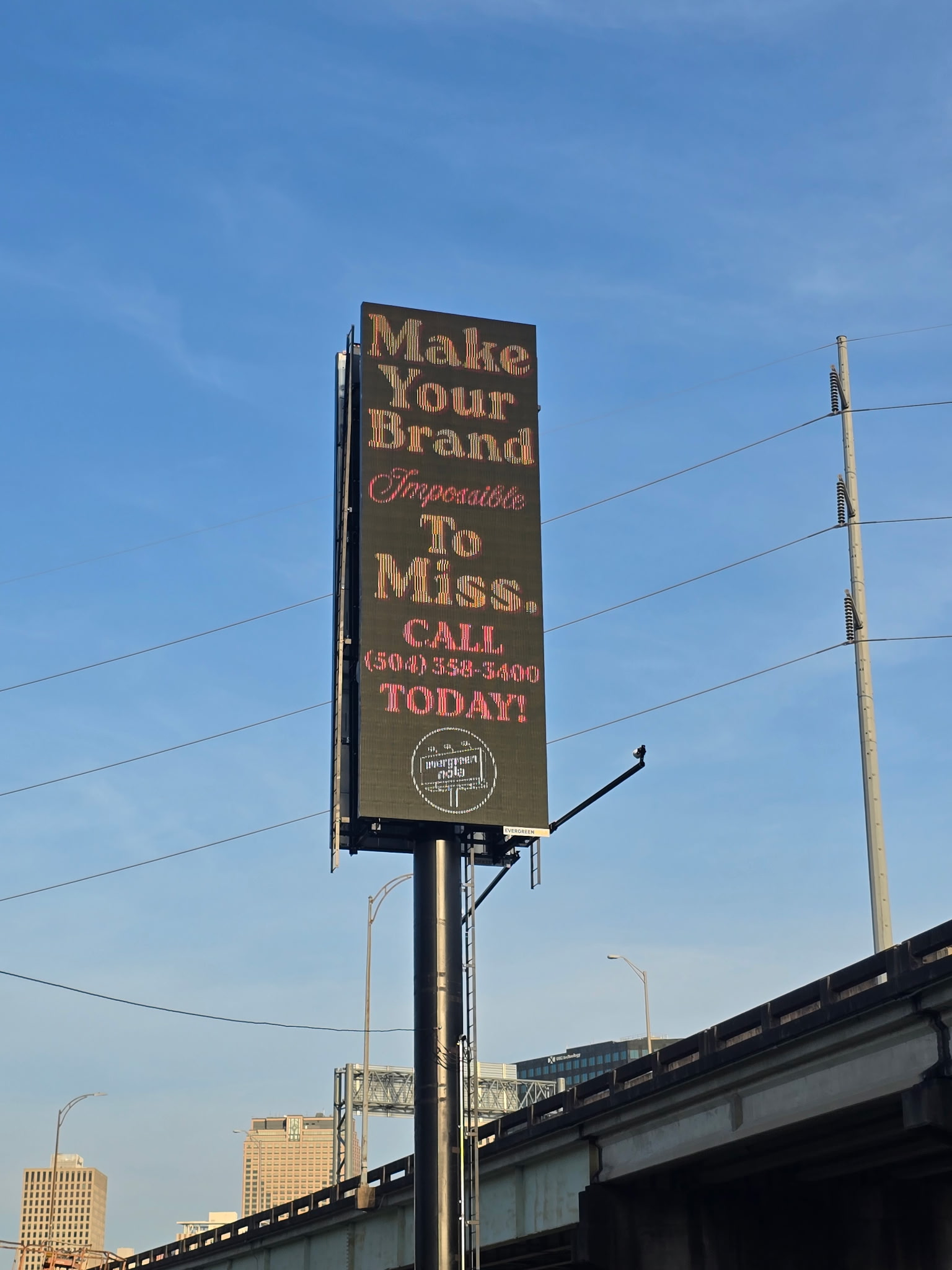 The I-10 digital billboard displaying an ad reading make your brand impossible to miss
