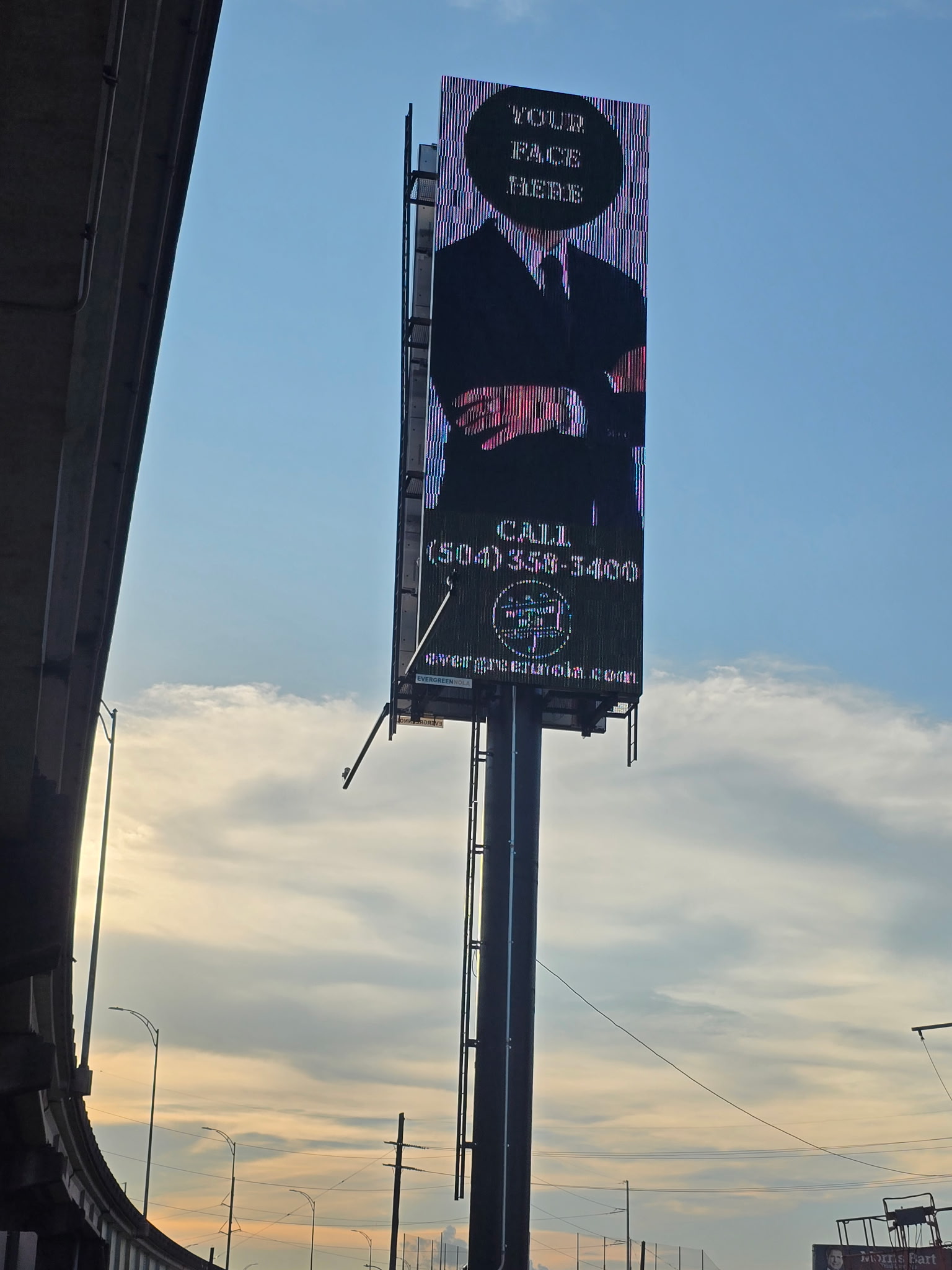 The I-10 digital billboard displaying an ad reading your face here above a suited silhouette
